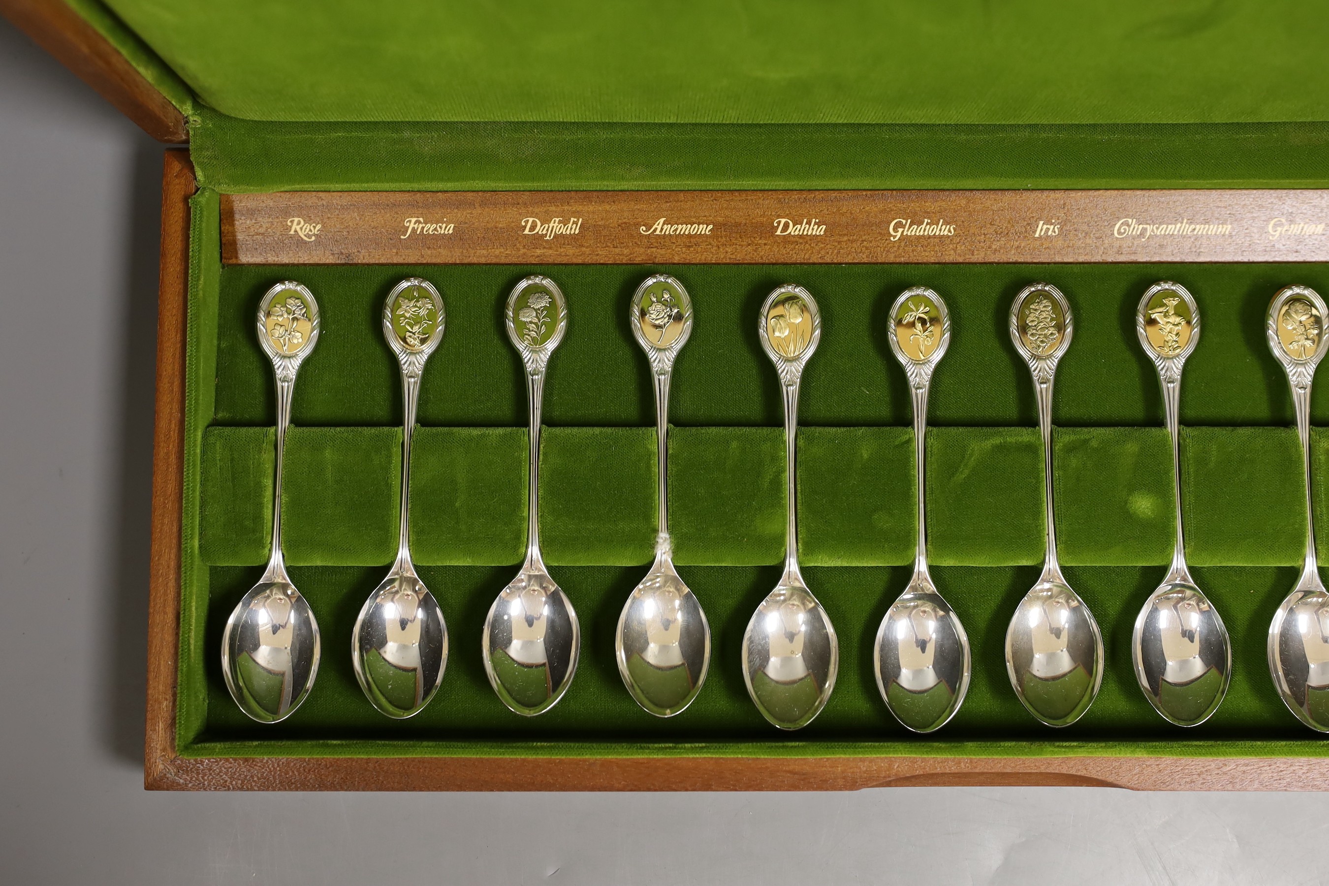 A cased set of twelve commemorative Royal Horticultural Society flower spoons, with silver gilt finials, gross 10oz